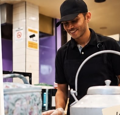 Vivek, co-founder of Chai Biskit, brewing chai at the counter